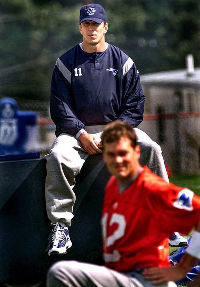 After injury, Drew Bledsoe looks on as Tom Brady stretches during a Patriots practice